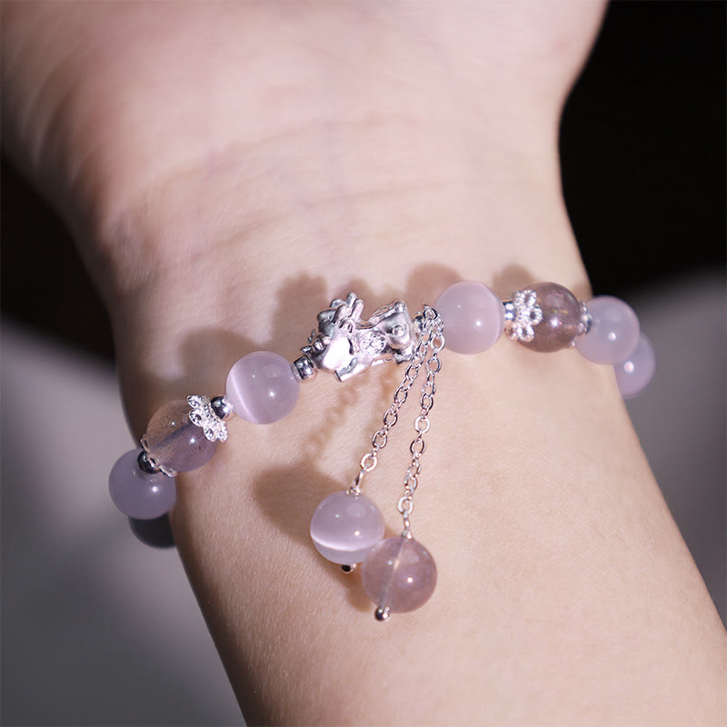 Cat's Eye PiXiu Bracelet – Worn on wrist showing pink strawberry quartz and silver PiXiu charm
