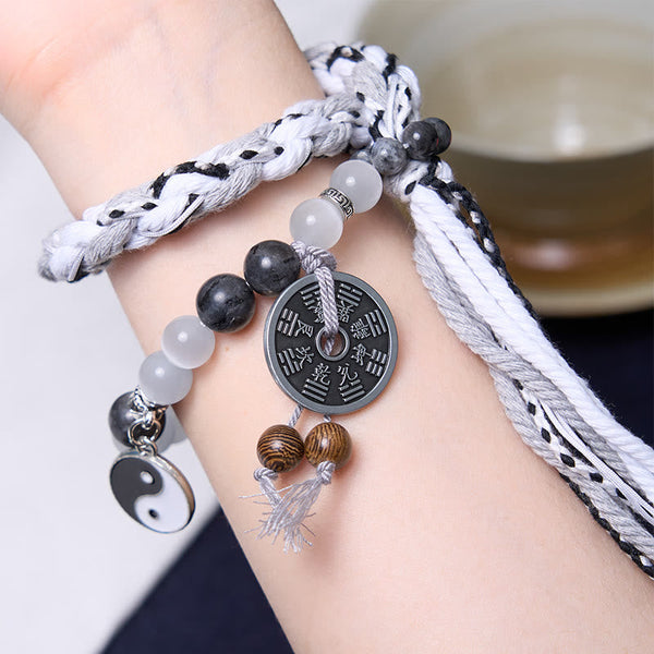 Mountain Ghost Yin Yang Bracelet - worn on wrist showing cords and bagua coin, spiritual bracelet