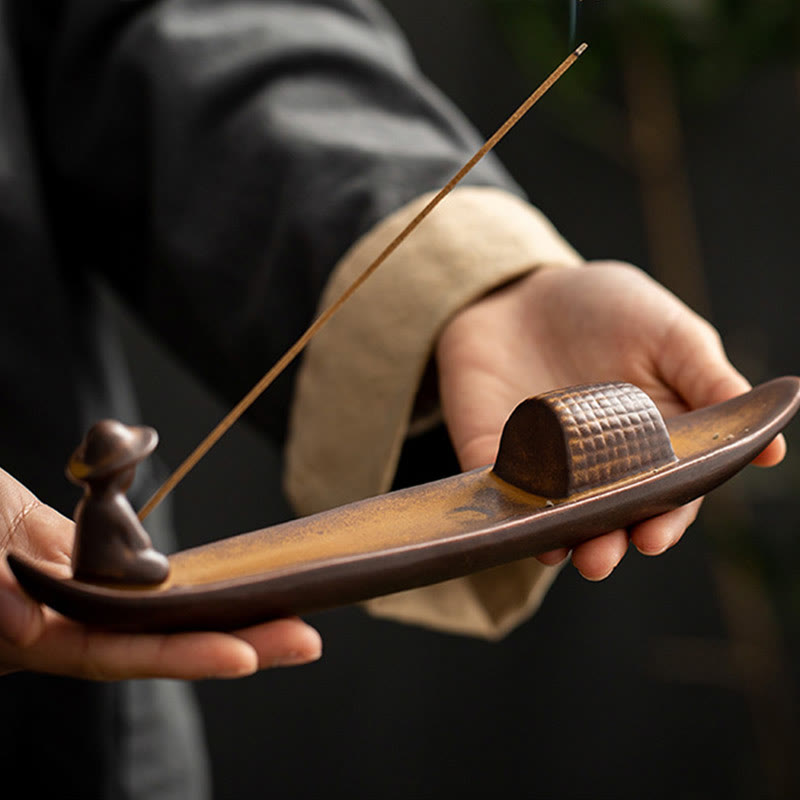 Lonely Fisherman Incense Burner – Handheld ceramic boat with smoke in garden setting, healing art