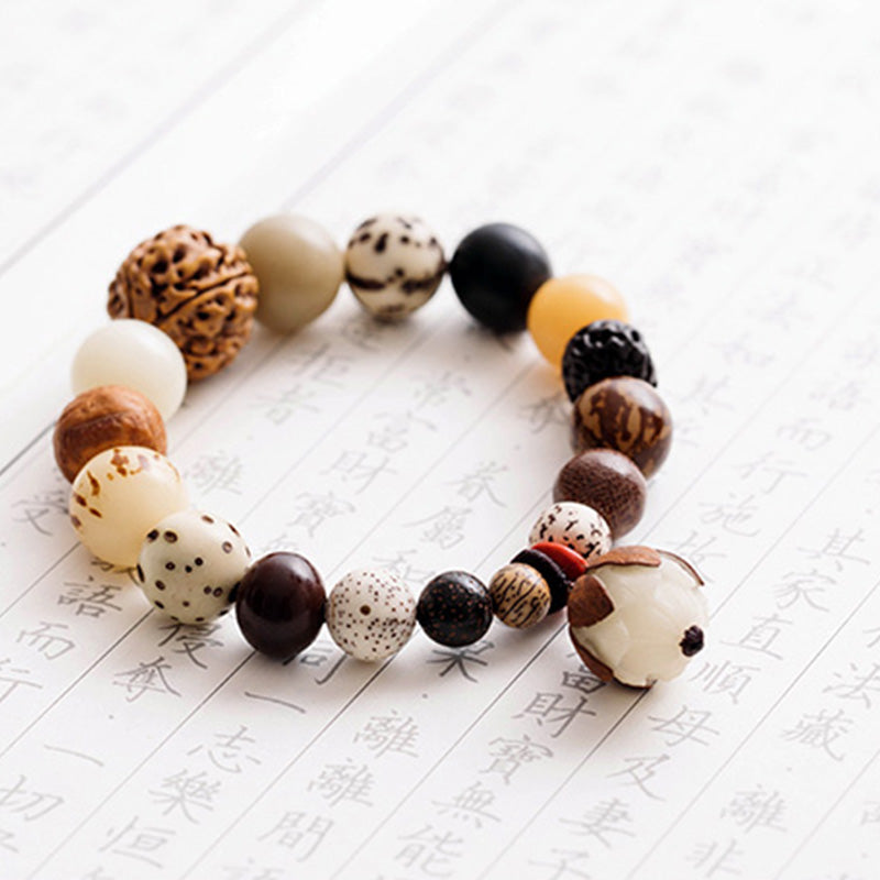 Bodhi Seed Lotus Mala – Curved flat lay on calligraphy paper showing dragon lotus beads, zen