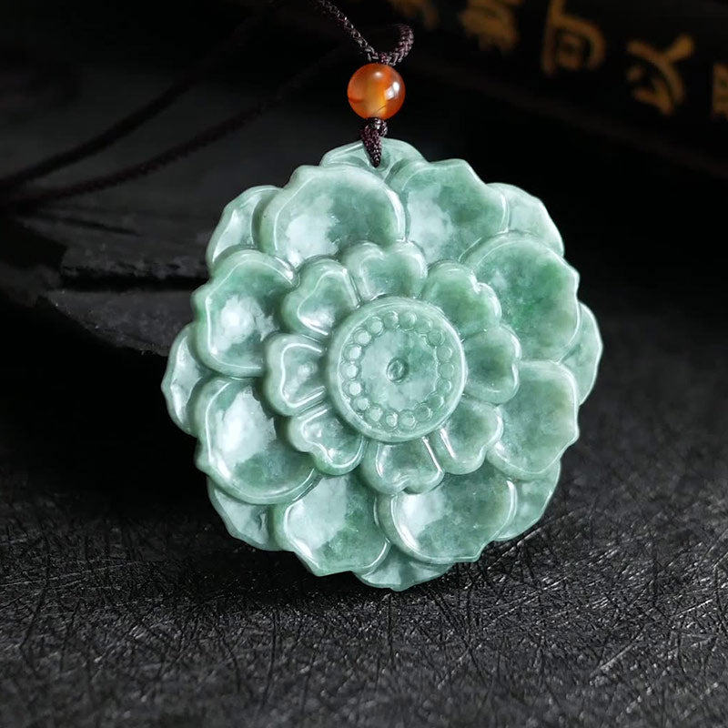 Jade Lotus Pendant Necklace – styled lotus carving on dark slate with warm gold calligraphy accent, Spiritual