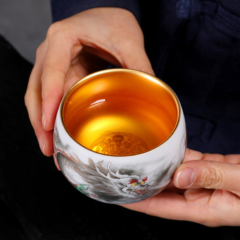 Dragon Gilt Porcelain Teacup - Gilded interior dragon cup held in both hands, ceremonial