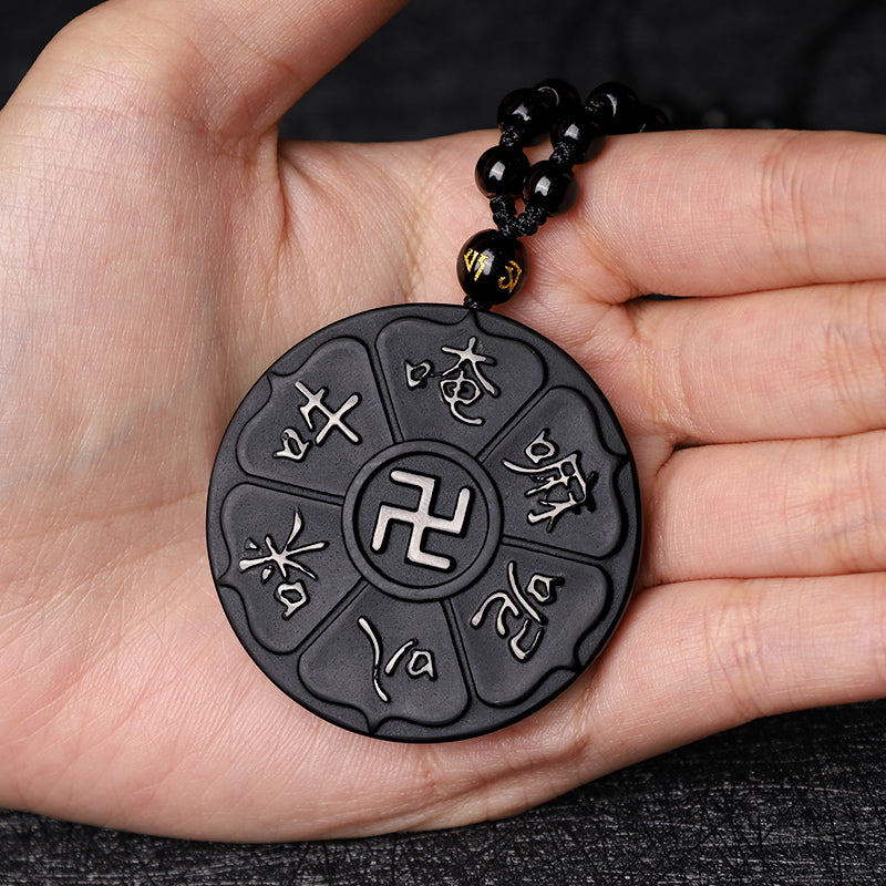 Black Obsidian Swastika Mantra Necklace - Held in open palm, carved swastika pendant with gold bead detail, protection talisman
