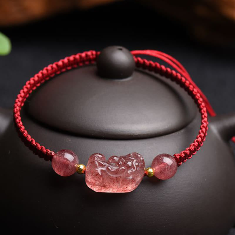 Strawberry Quartz PiXiu Red Bracelet – on black teapot lid, red cord pink quartz PiXiu, love luck