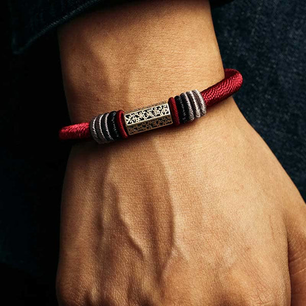 Om Mani Padme Hum Red Bracelet – Worn top-down view, geometric silver bead on red cord, men’s meditation bracelet