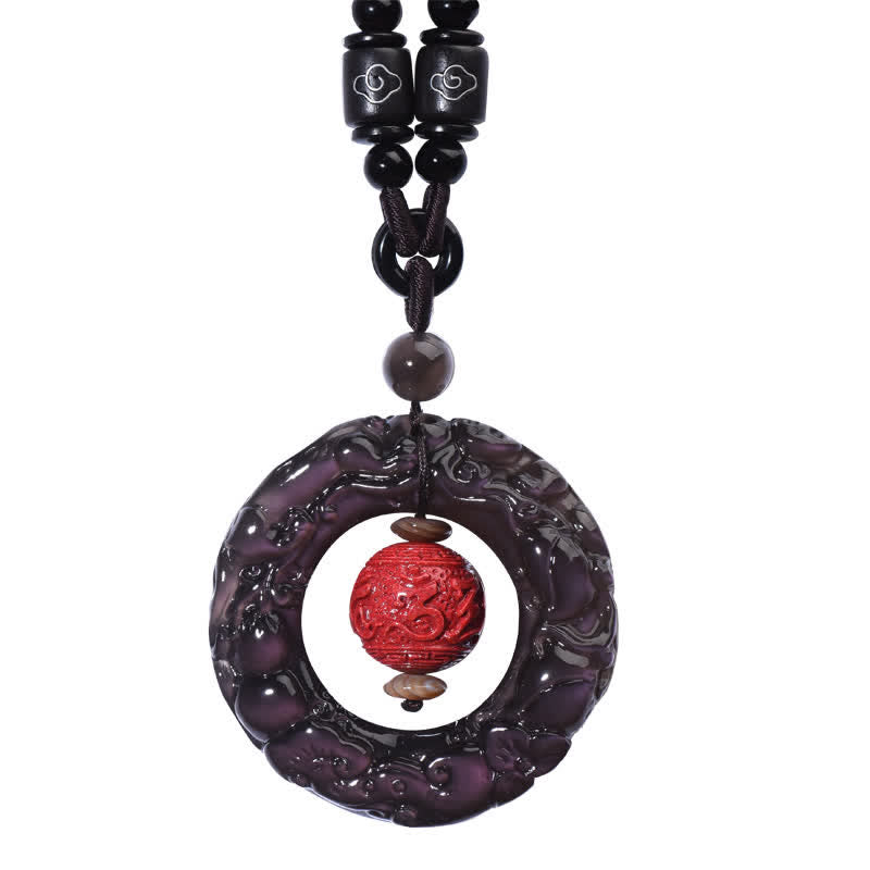 Rainbow Obsidian PiXiu Pendant – Isolated rainbow obsidian PiXiu pendant with cinnabar on white