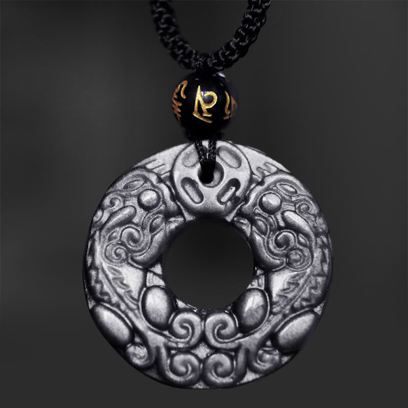 Silver Sheen Obsidian Double PiXiu Necklace – Metallic obsidian disc with PiXiu relief on dark background, talisman