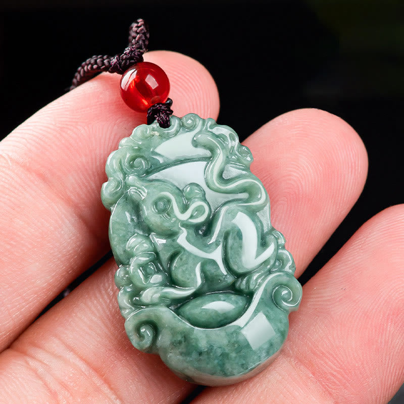 Jade Zodiac Prosperity Necklace – Monkey zodiac pendant cradled in hand, black backdrop, playful