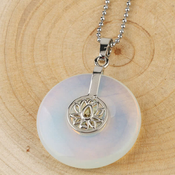 Crystal Amethyst Pink Crystal Lotus Necklace – Opalite lotus donut pendant on ball chain over wood, iridescent milky blue healing crystal