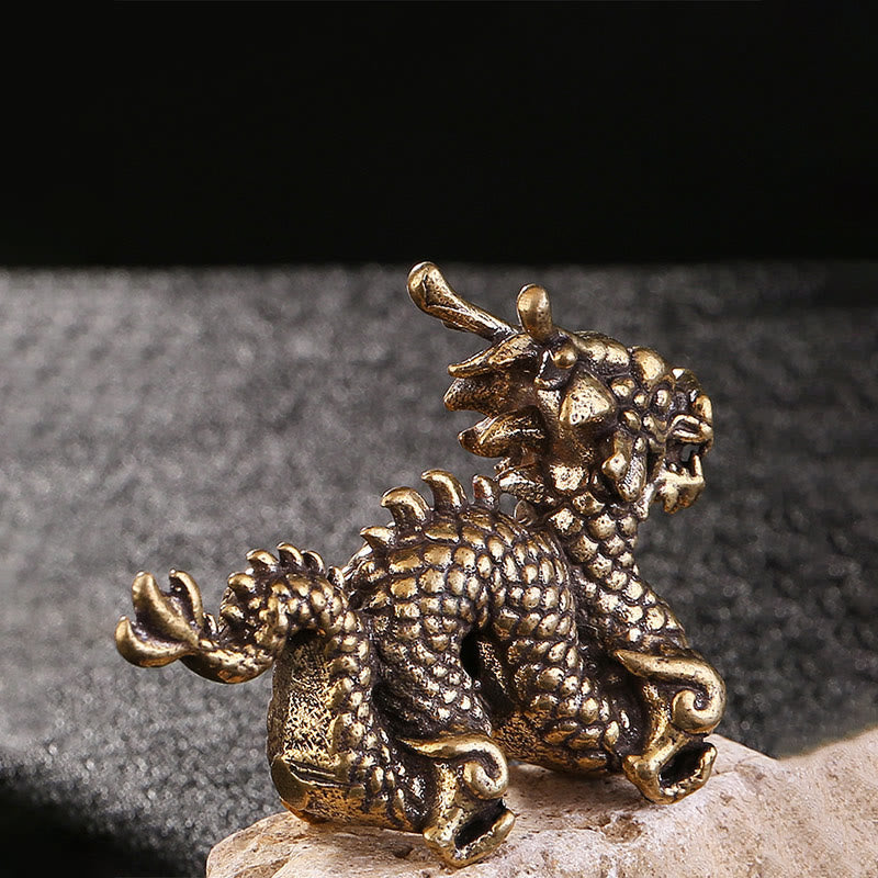 Auspicious Brass Dragon Decoration - Rear view of scaled dragon back on textured stone, artisan craft