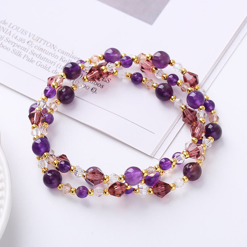 Amethyst triple-strand wrap bracelet with deep purple quartz beads, dusty rose crystal bicones and gold spacers on white surface, feminine bohemian gemstone jewelry