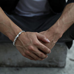 Tibetan Lotus White Copper Bracelet worn on wrist in outdoor lifestyle setting, twisted rope