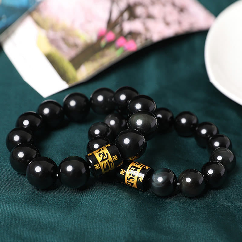 Rainbow Obsidian Bracelet – Pair of black mantra bead bracelets styled with floral book on green fabric, gift idea
