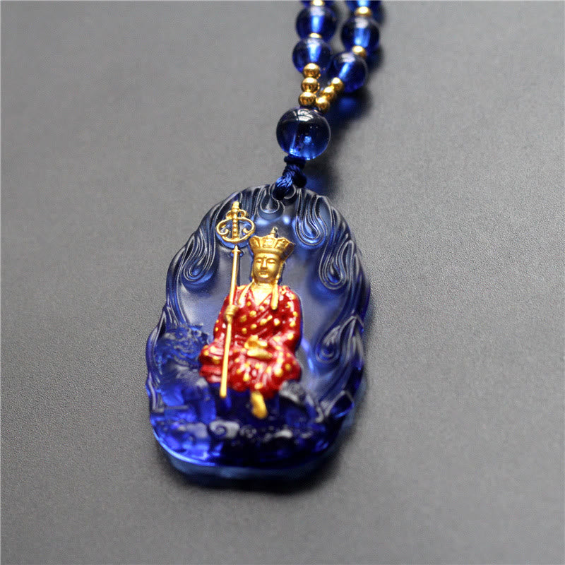 Ksitigarbha Buddha Liuli Crystal Necklace – Translucent amber Buddha figure with detailed robe patterns, mindful ornament