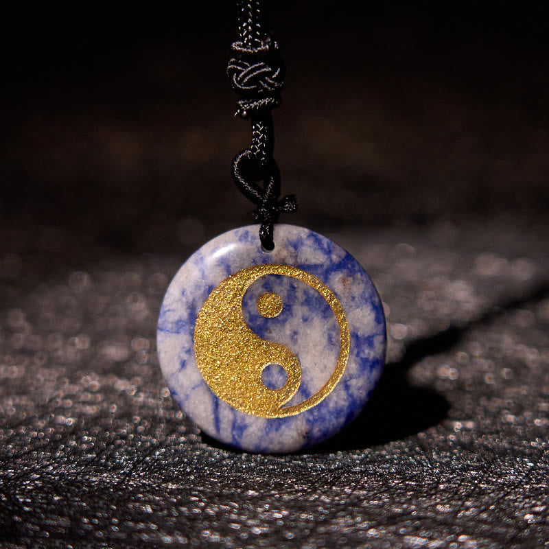 Yin Yang Crystal Necklace – Blue sodalite pendant with gold yin-yang inlay, natural white and blue mineral marbling with text