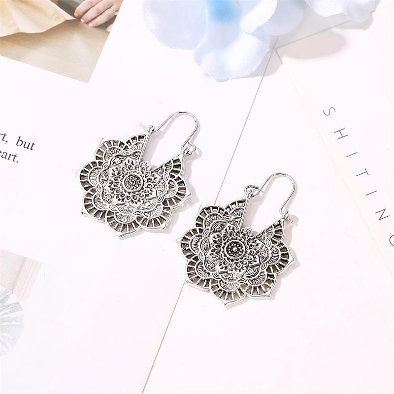 Tibetan Copper Lotus Engraving Drop Earrings – Matching pair of antique copper mandala drop earrings with intricate lotus flower filigree and oxidized metal finish on white paper