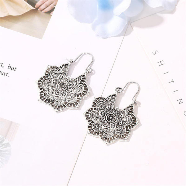 Tibetan Copper Lotus Engraving Drop Earrings – Matching pair of antique copper mandala drop earrings with intricate lotus flower filigree and oxidized metal finish on white paper