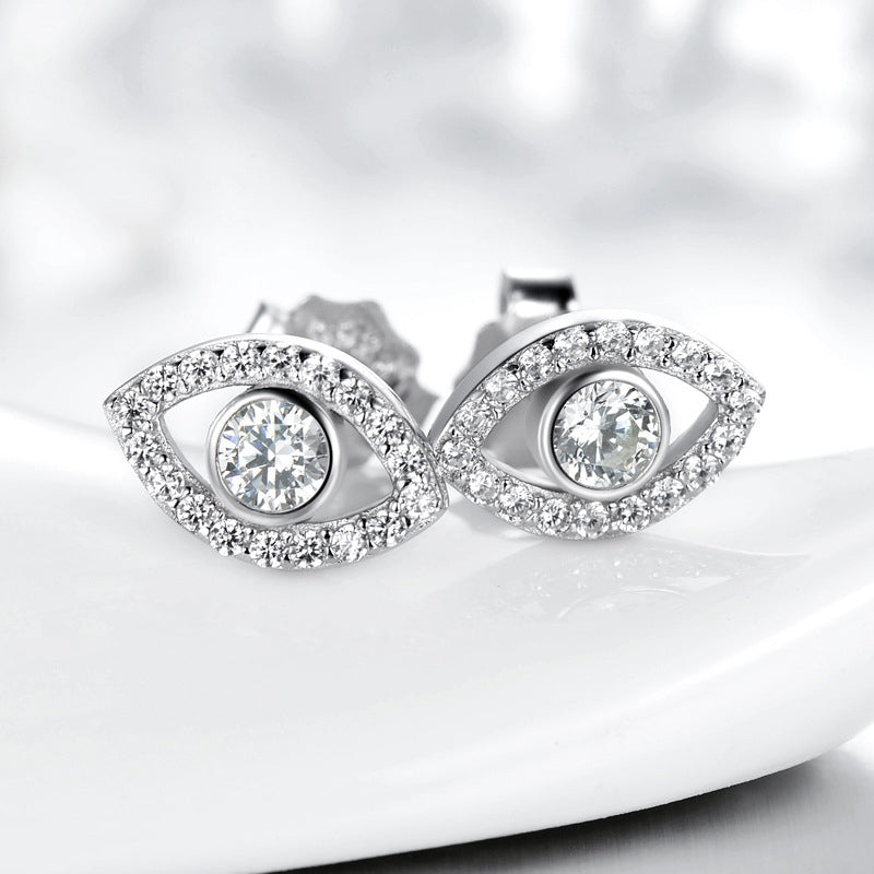 925 Silver Evil Eye Stud Earrings on Glossy White Ceramic Dish, Pavé Crystal Halo Design