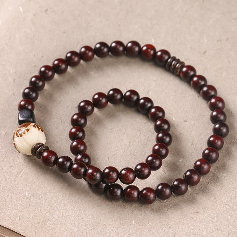 Red Sandalwood Lotus Bodhi Seed Bracelet – Double-loop dark sandalwood beads with carved cream lotus focal bead, flat lay