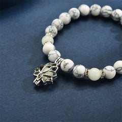 Tibetan Turquoise Glowstone Lotus Bracelet – white howlite with glowing cream center lotus charm close-up, lotus jewelry