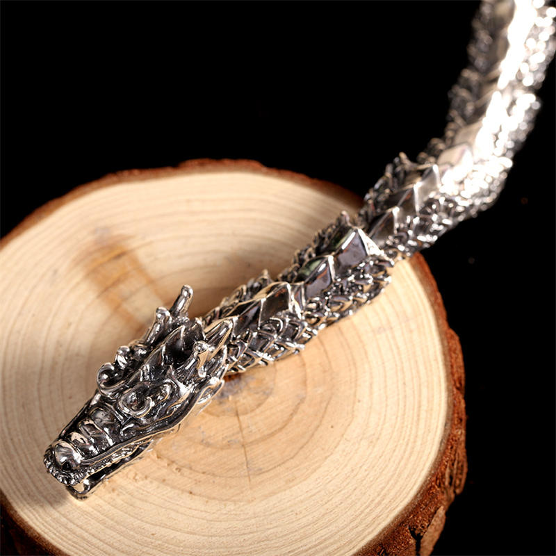 Sterling Silver Dragon Bangle - Scaled body links with horn details on black background, gothic luxury