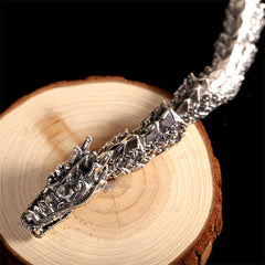 Sterling Silver Dragon Bangle - Scaled body links with horn details on black background, gothic luxury