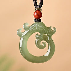 White Jade Cyan Jade Dragon Pendant – carved spiral dragon in sage green with red bead, auspicious