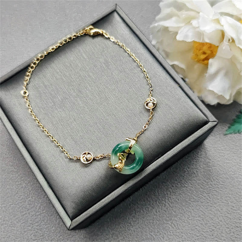Cyan Jade Harmony Bracelet - koi fish charm detail with carved scales and tail, zen