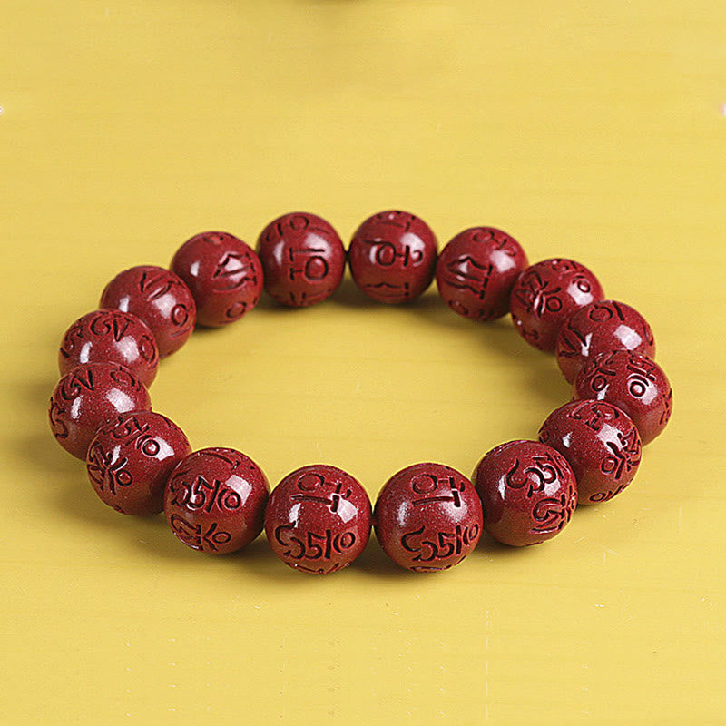 Double PiXiu Cinnabar Bracelet – Red cinnabar bead bracelet front view on yellow, wellness jewelry
