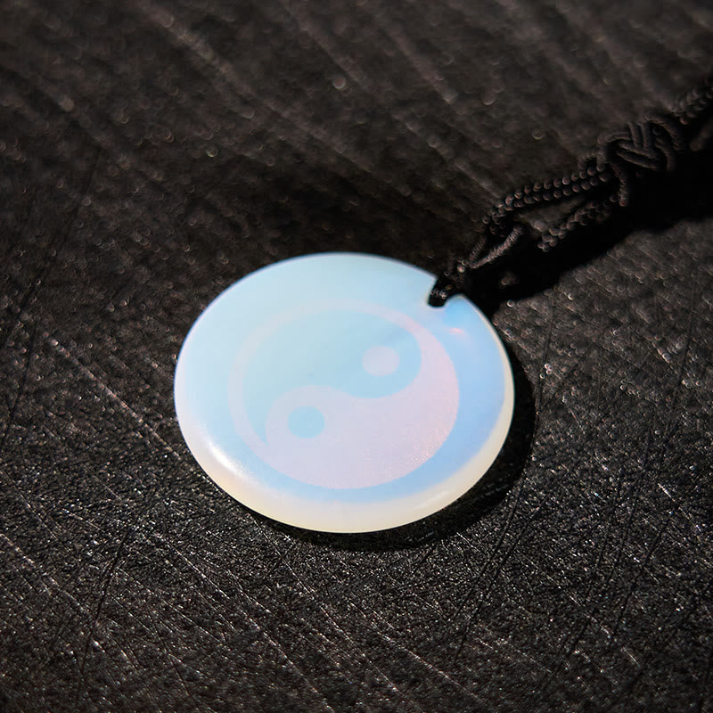Yin Yang Crystal Necklace – Opalite pendant with engraved yin-yang symbol, iridescent milky-blue color shift on black cord, d