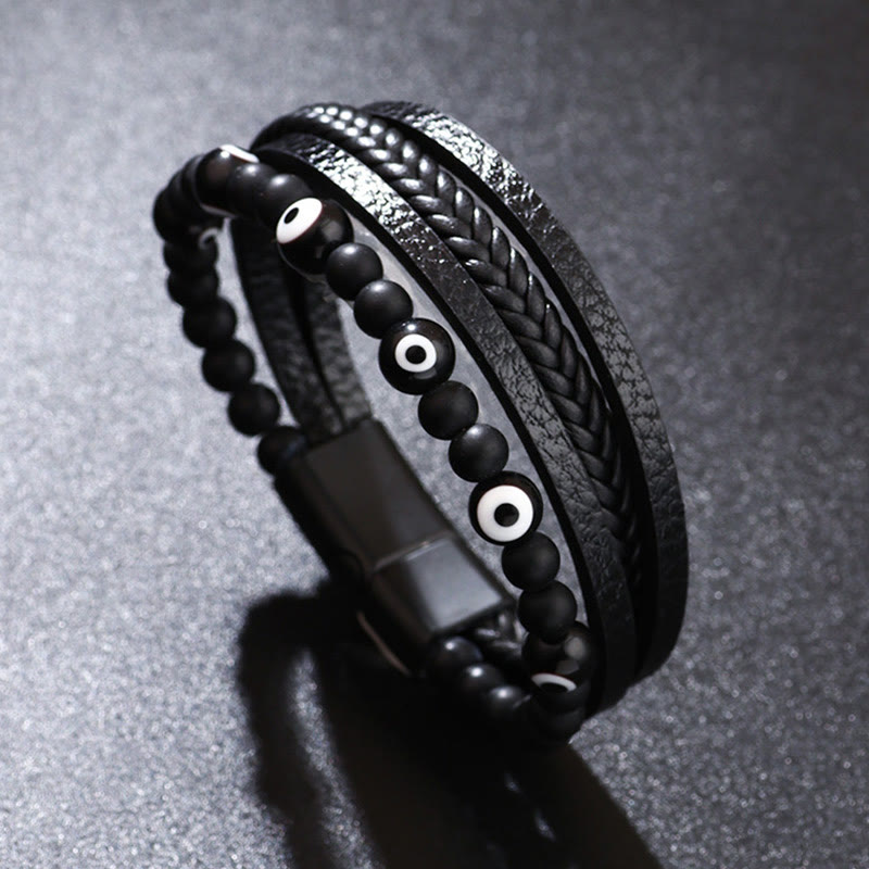 Evil Eye Tiger Eye Bracelet – All black beaded leather bracelet with white evil eye on charcoal surface