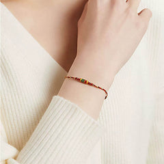 Koi Fish Wealth Bracelet – Red rope bracelet worn on wrist with koi charm, protection amulet