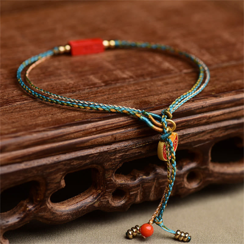 Cinnabar Braided Bracelet - Adjustable cord bracelet on carved wood stand, red gold charm