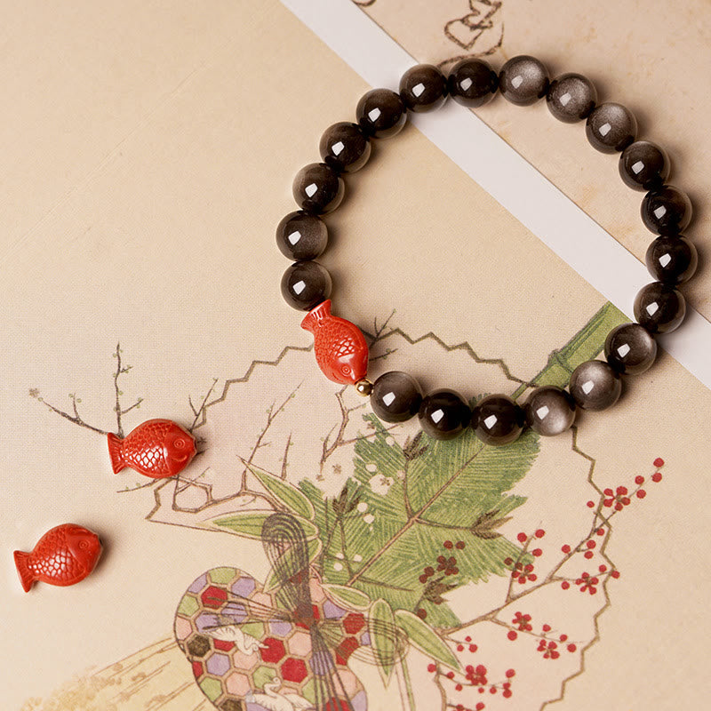 Silver Sheen Obsidian Bracelet – close-up koi fish cinnabar carving, shiny obsidian stones