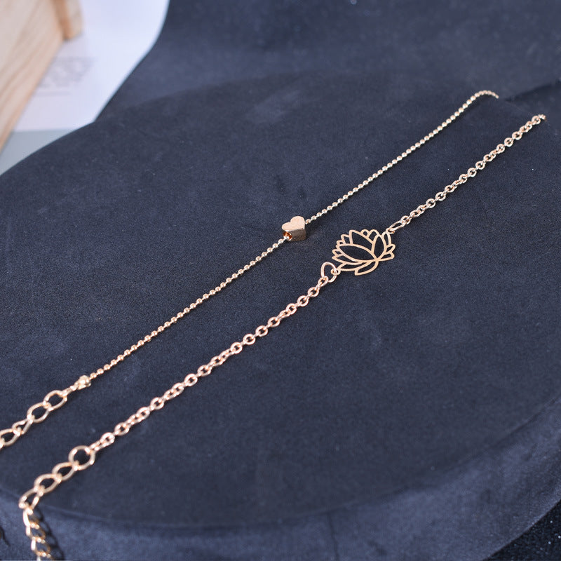 Lotus Heart Enlightenment Bracelet - Parallel lotus and heart bracelets on dark velvet flat lay, love bracelet