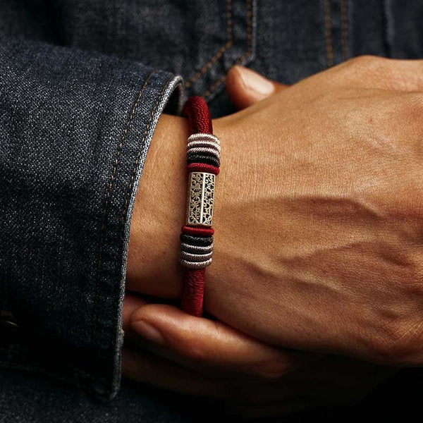 Om Mani Padme Hum Red Bracelet – Worn on wrist with denim, red cord with silver filigree bead, men’s spiritual bracelet