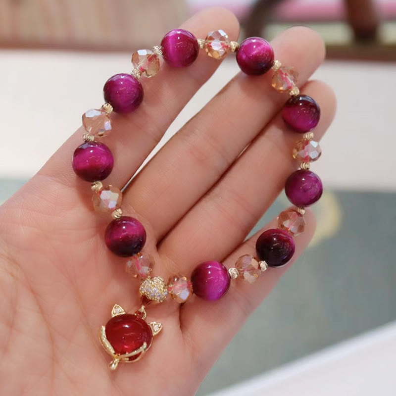 Red Tiger Eye PiXiu Fox Bracelet – Hand showing red beads fox charm bracelet, romantic protection