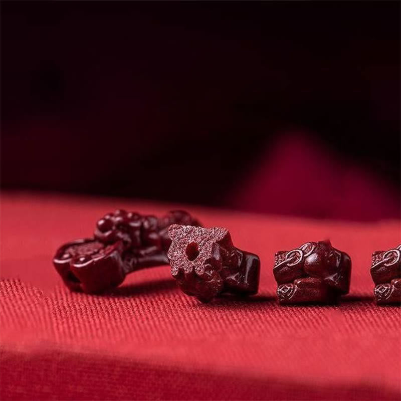 Handcrafted PiXiu Cinnabar Wealth Luck Braided Bracelet – scattered cinnabar beads and components on fabric, raw