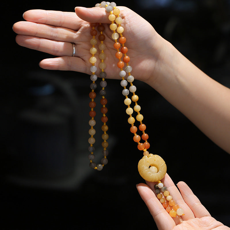 Golden Silk Jade Flower Pendant Necklace – cream amber rust beads with carved circular pendant, central hole and dangle bead