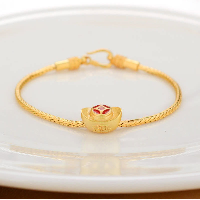 18K Gold Om Mani Padme Hum Koi Fish Bracelet – gold ingot yuanbao charm with red enamel on braided chain, white dish, elevated front view