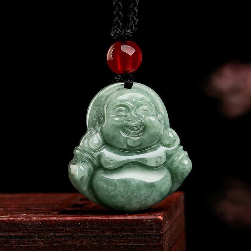 Laughing Buddha Jade Necklace - celadon green pendant with red carnelian bead on dark backdrop, front studio, Abundance