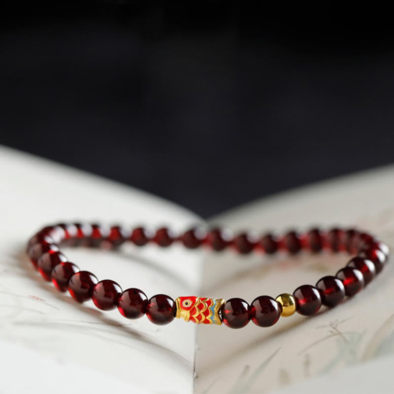 999 Gold Koi Bracelet – 45-degree angle showing koi fish detail, natural garnet, gold koi wealth bracelet