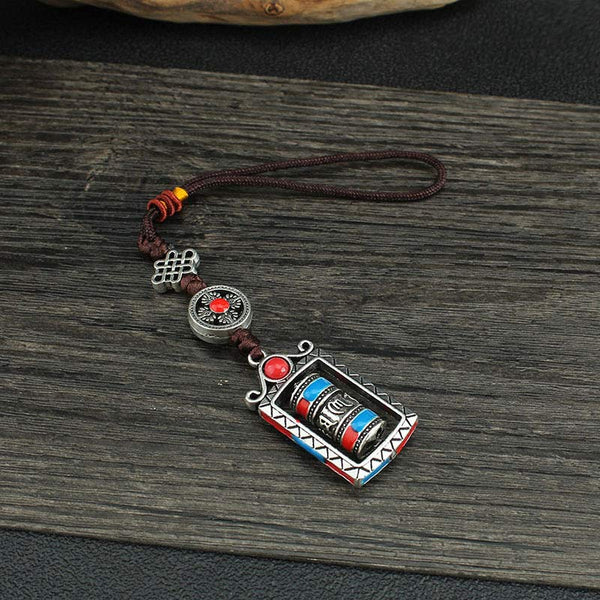Om Mani Padme Hum Prayer Wheel Keychain – Top-down on rustic wood with fabric, full pendant assembly, Buddhist charm