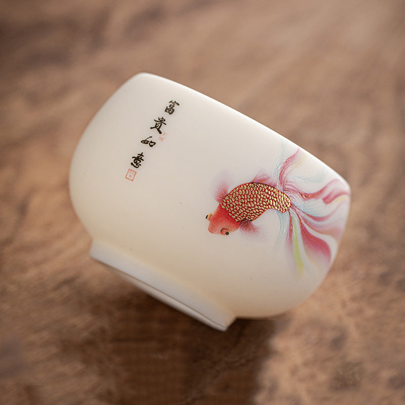 Koi Fish Ceramic Teacup - close-up of colorful koi fish artwork on white porcelain