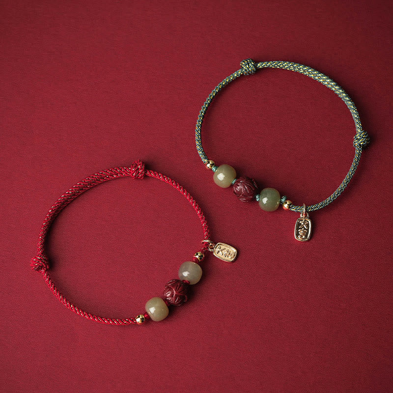 Hetian Jade Cinnabar Lotus Bracelet – Red and teal cord variants paired on crimson background, dual color bracelet