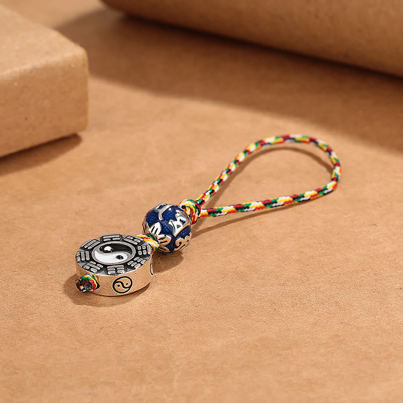 Yin Yang Bagua Keychain – Side angle displaying disc thickness with yin-yang symbol and cloisonne blue bead, copper charm