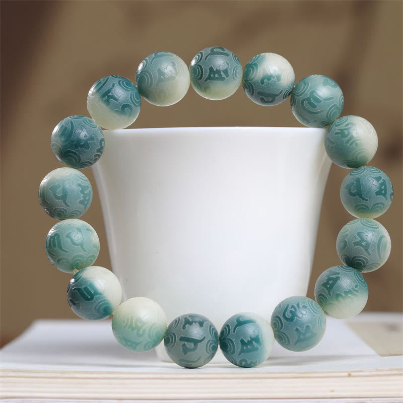 Bodhi Seed Om Mani Padme Hum Bracelet – Arched over white vessel revealing carved cloud patterns, spiritual jewelry