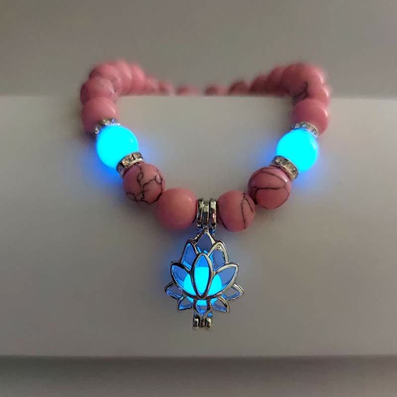 Tibetan Turquoise Glowstone Lotus Bracelet – pink howlite beads with cyan glowing lotus pendant on stand, pink glowstone bracelet