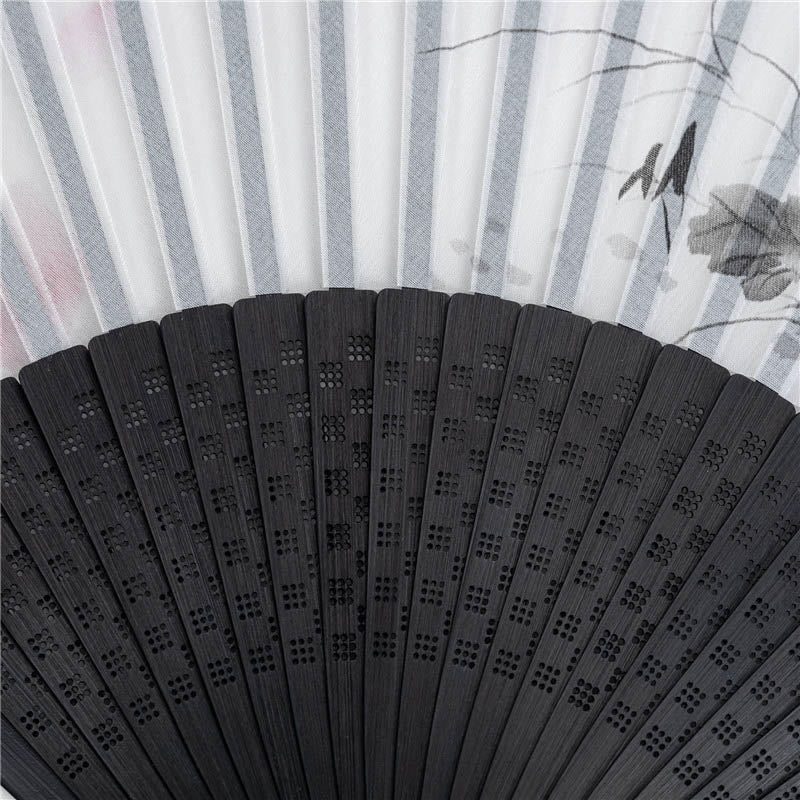 Black Fan Rib Detail – Macro shot of carved geometric lattice on black bamboo folding fan ribs, silk fan