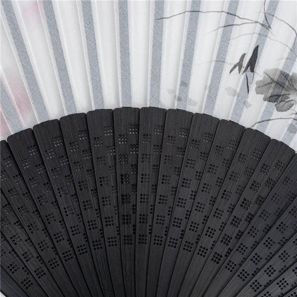 Black Fan Rib Detail – Macro shot of carved geometric lattice on black bamboo folding fan ribs, silk fan